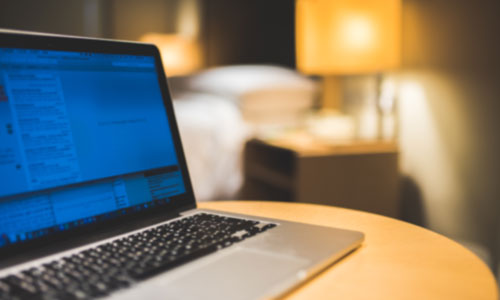 laptop showing hospitality technology in hotel service